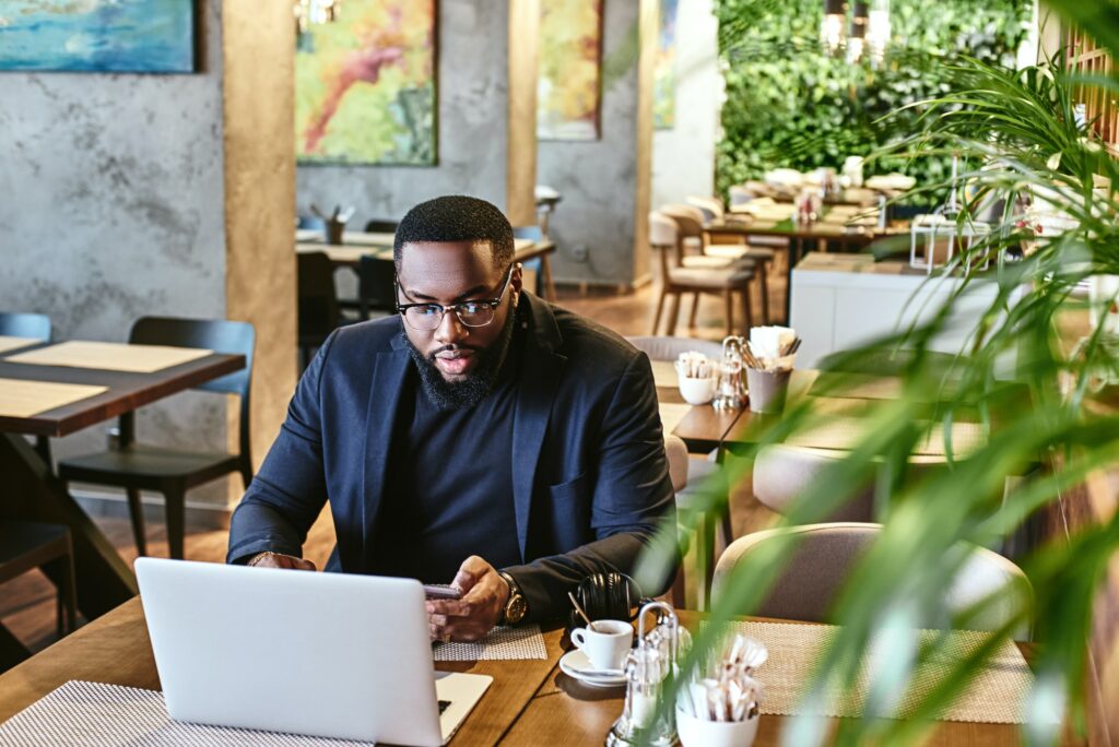 Nothing can beat hard work. African american businessman is working, using his laptop while resting